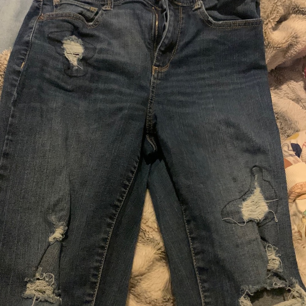 Ripped blue jeans pants